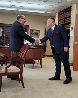 Lionel E. Bashore shaking hands with Supreme Court Justice David Viviano