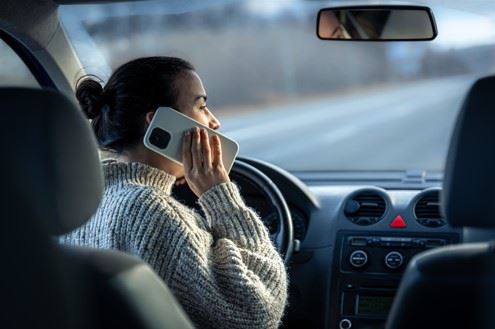 woman talking on cell phone while driving