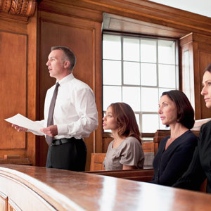 our-approach-104821169 A lawyer is speaking to a judge in defending his client