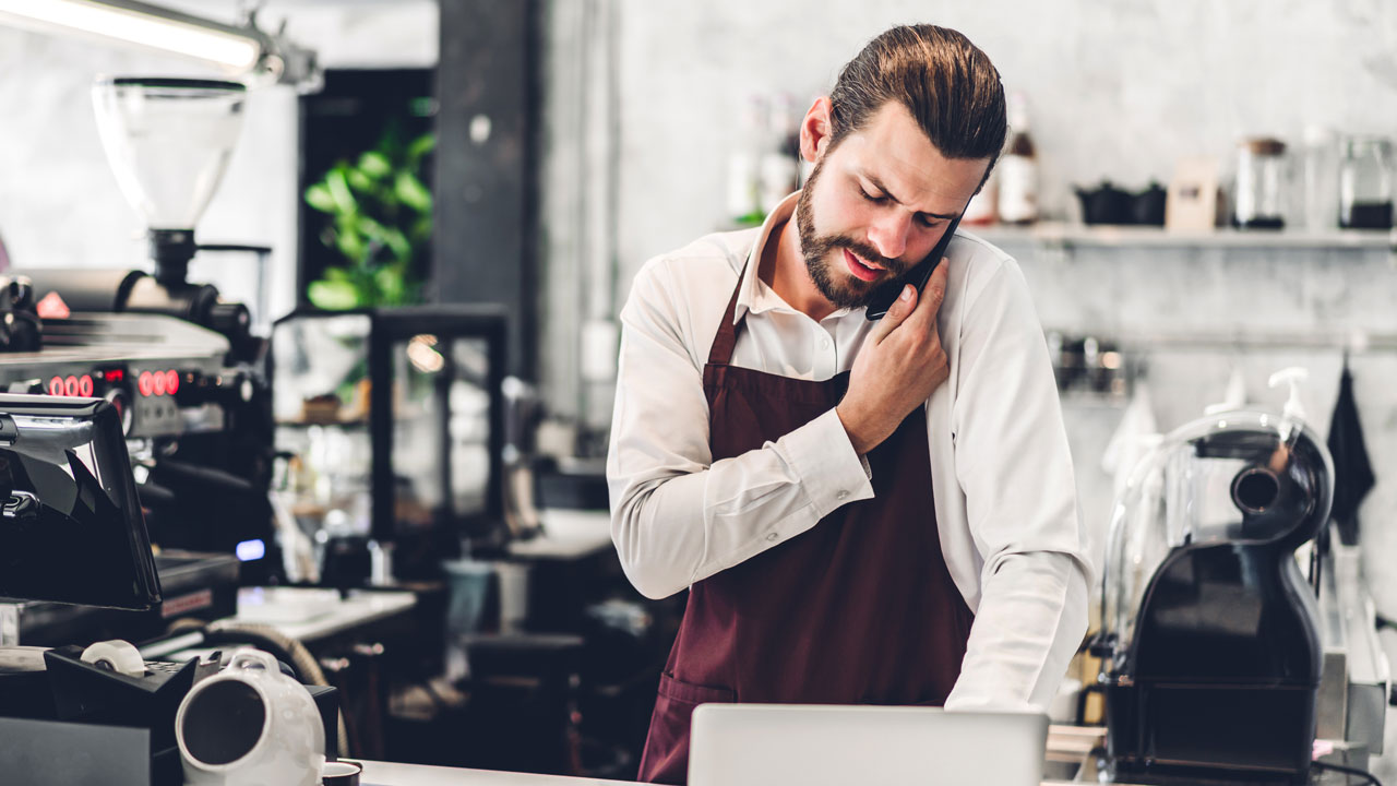 istockphoto-1632915709-2048x2048 A coffee shop owner is on the phone seeking business representation in a legal case